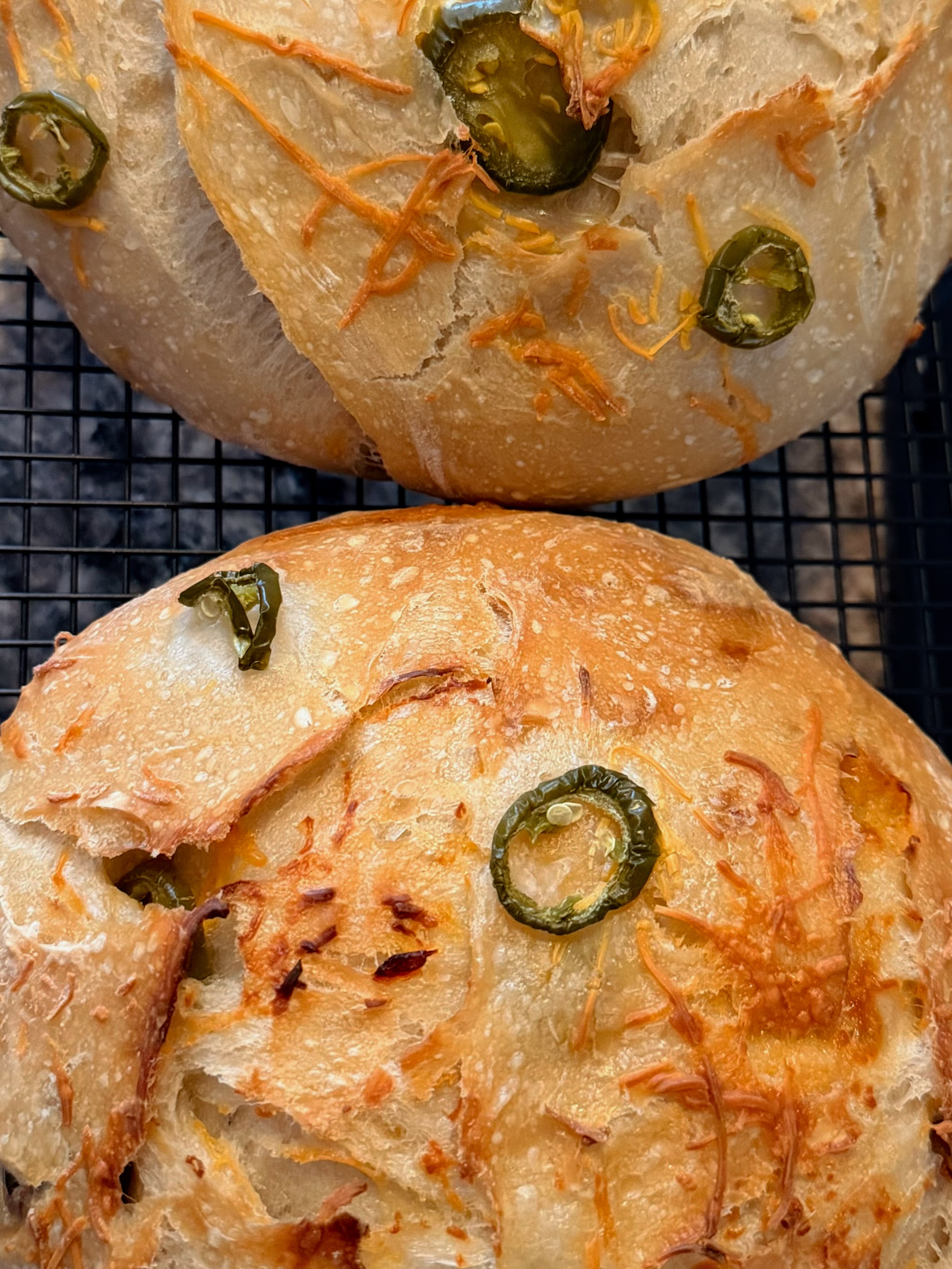 Freshly baked Madisen Made jalapeño cheddar sourdough on a cooling rack